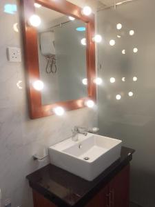 a bathroom with a white sink and a mirror at Hummingbird St.Clare Villas in Dimbula +70 photos