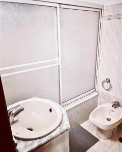 a white bathroom with a sink and a toilet at New in Loures in Lisbon