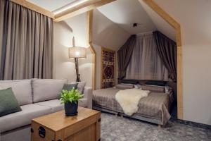 a living room with two beds and a couch at Siedlisko Babia Góra in Zawoja +90 photos