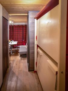 a hallway leading to a dining room with a table at Ski Chalet located Meribell in Les Allues