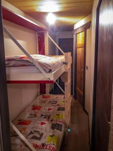 a room with two bunk beds and a hallway at Ski Chalet located Meribell in Les Allues