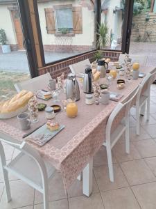 a table with food and utensils on it at Roulotte la passe pierre in Pendé