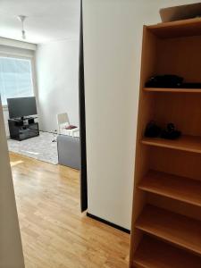 a room with a door open to a living room at Sunny 4th-Floor Park-View Studio Escape in Turku