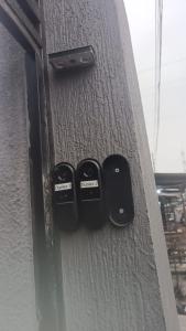 a close up of three remote controls on a wall at Duplex nr 3 à Bandal in Kinshasa