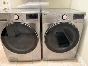 two washing machines are sitting next to each other at Cozy home near YVR with free parking in Richmond
