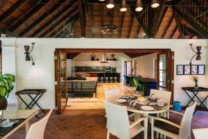 a dining room and living room with a table and chairs at Indian Summer House in Mūvattupula