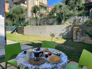 a table with a plate of food on it at Residence Mare Verde in Pietra Ligure