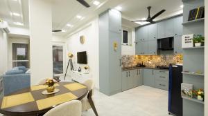 a kitchen and dining room with a table and chairs at The Afternoon Stays in Mohali