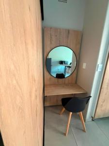 a mirror on a desk with a chair in a room at Green Haven 2 in Tzaneen