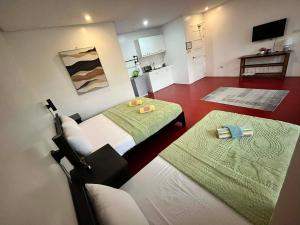 a small room with two beds and a kitchen at Mamma Rose Hotel in Legazpi