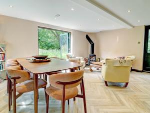 a dining room with a table and chairs at Swallows Bottom in Henley
