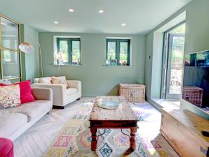 a living room with a couch and a coffee table at Swallows Bottom in Henley