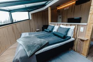 a bed in the middle of a room at Livo Arctic Resort in Posio