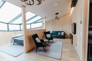 a living room with two chairs and a couch at Livo Arctic Resort in Posio