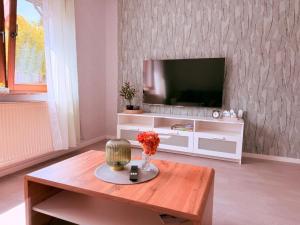 a living room with a television and a coffee table at Ferienwohnung Ehrenberg-Feeling in Ehrenberg