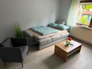 a small living room with a bed and a coffee table at Ferienwohnung Ehrenberg-Feeling in Ehrenberg
