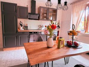 a kitchen with a table with a vase of flowers on it at Ferienwohnung Ehrenberg-Feeling in Ehrenberg