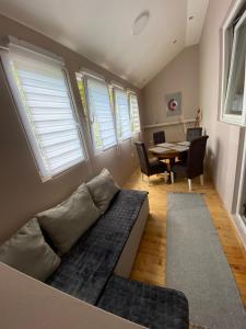 a living room with a couch and a table at Топсоба12 in Niš