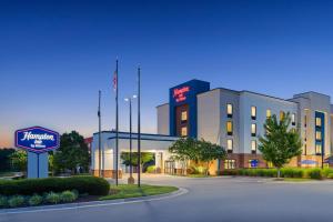 a hotel building with a sign in front of it at Hampton Inn Farmville in Farmville