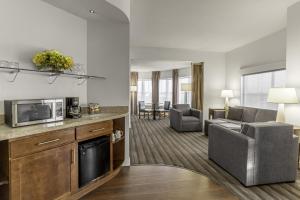 a living room with a kitchen and a living room with a couch at Hyatt House Richmond - Short Pump in Short Pump