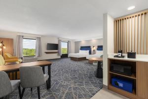 a hotel room with a bed and a desk at Hampton Inn Farmville in Farmville