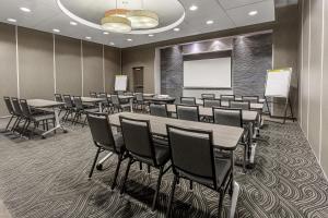 a conference room with tables and chairs and a whiteboard at Hyatt House Richmond - Short Pump in Short Pump