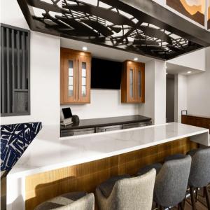 a kitchen with a white counter and chairs at Hampton Inn & Suites Richmond Glenside in Richmond