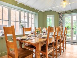a dining room with a wooden table and chairs at Scarrow Beck House in Hanworth
