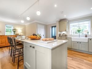 a kitchen with white cabinets and a white counter top at Scarrow Beck House in Hanworth