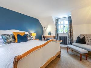 a bedroom with a large bed and a window at Scarrow Beck House in Hanworth +13 photos