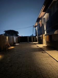 an empty courtyard of a building with a chair at Duplex nr 3 à Bandal in Kinshasa