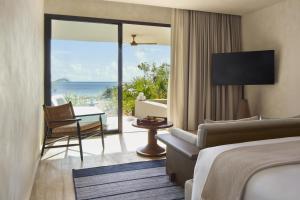 a hotel room with a bed and a view of the ocean at Alila Mayakoba by Hyatt in Playa del Carmen