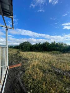 a view of a field from the porch of a house at Mukha in Tbilisi City