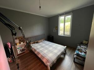 a bedroom with a bed and a window at Mukha in Tbilisi City