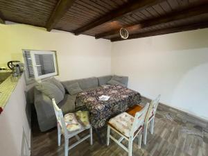 a living room with a table and a couch at Mukha in Tbilisi City