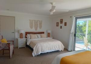 a bedroom with a bed and a window at "Casa Serena" - Spacious Entire Holiday Home in Caboolture