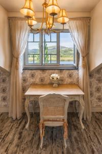 a dining room with a table and a window at Casona Naviega in Navia