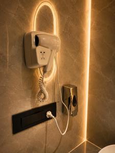 a phone on a wall in a bathroom at Panipat Prime in Pānīpat