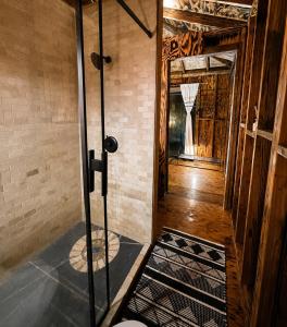 a room with a shower and a door to a hallway at Sunset Calm Retreat Bungalow in Haleiwa