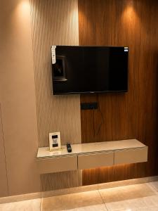 a flat screen tv hanging on a wall at Panipat Prime in Pānīpat