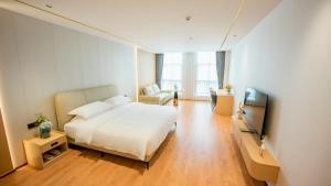 a hotel room with a bed and a television at 玉恒酒店 in Sihui