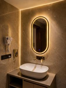 a bathroom with a sink and a mirror at Panipat Prime in Pānīpat