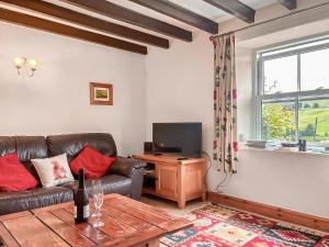 a living room with a couch and a television at Windy Ridge Low Row in Feetham +22 photos
