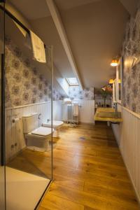 a bathroom with a toilet and a sink at Casona Naviega in Navia +38 photos