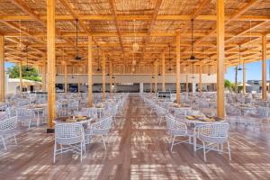 a banquet hall with white tables and chairs at Pickalbatros Royal Moderna Sharm "Aqua Park"- All inclusive in Sharm El Sheikh