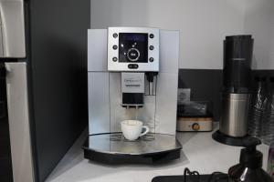 a coffee machine sitting on a counter with a cup at Ferienwohnung Frankenruhe in Strullendorf