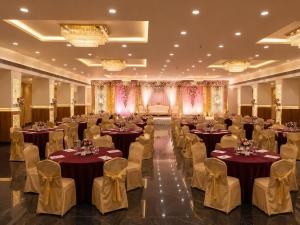 a banquet hall with tables and chairs in a room at Hotel Harsh Vilas-Near Tajmahal Agra in Agra