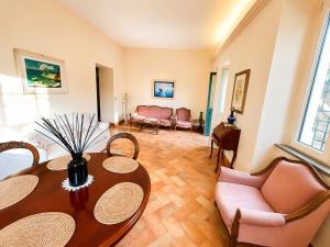 a living room with a table and chairs at Punta Fortino Resort in Agropoli