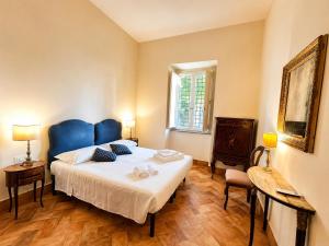a bedroom with a blue bed in a room at Punta Fortino Resort in Agropoli