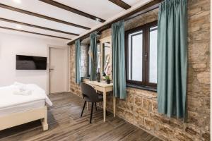 a bedroom with a bed and a desk in a room at Split Old Town Rooms Matushko in Split